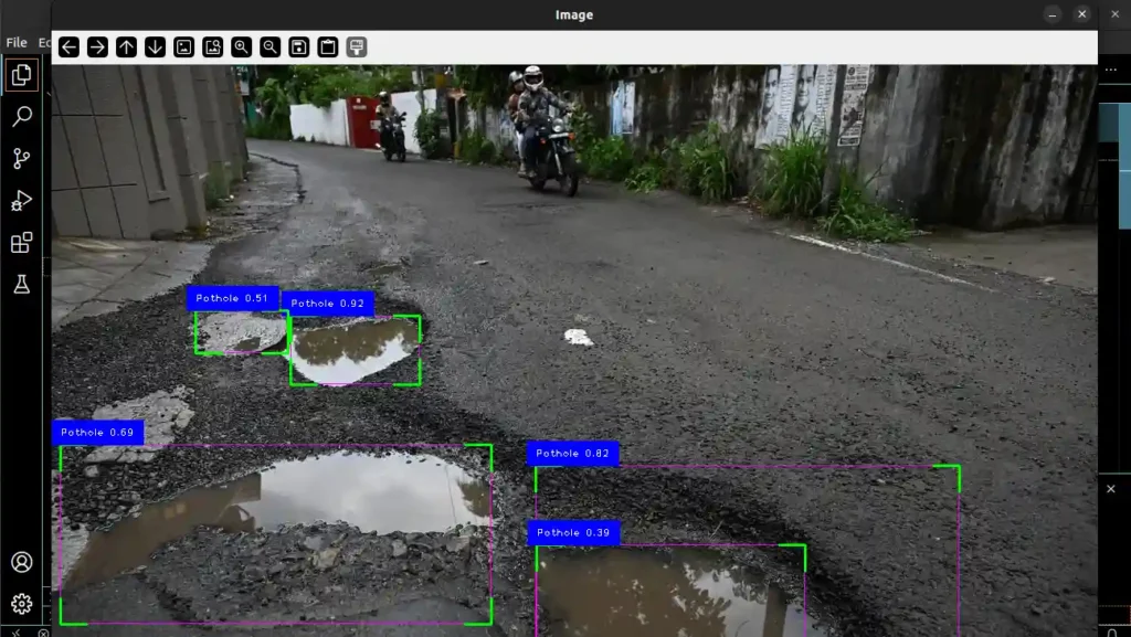 a road with four potholes filled with water, detected by a computer program