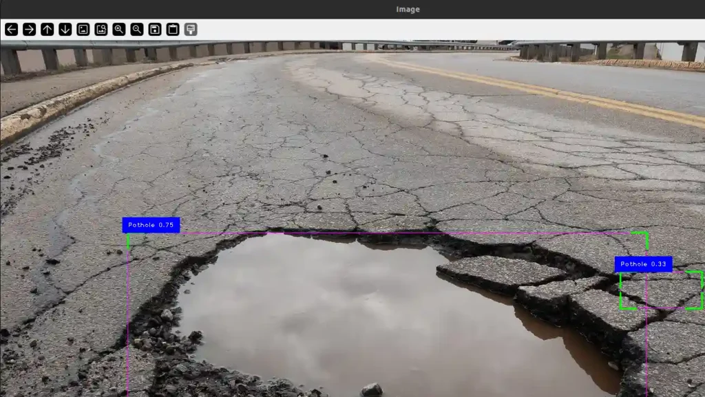 A highway with a big pothole in the centre, filled with water, detected by a computer program